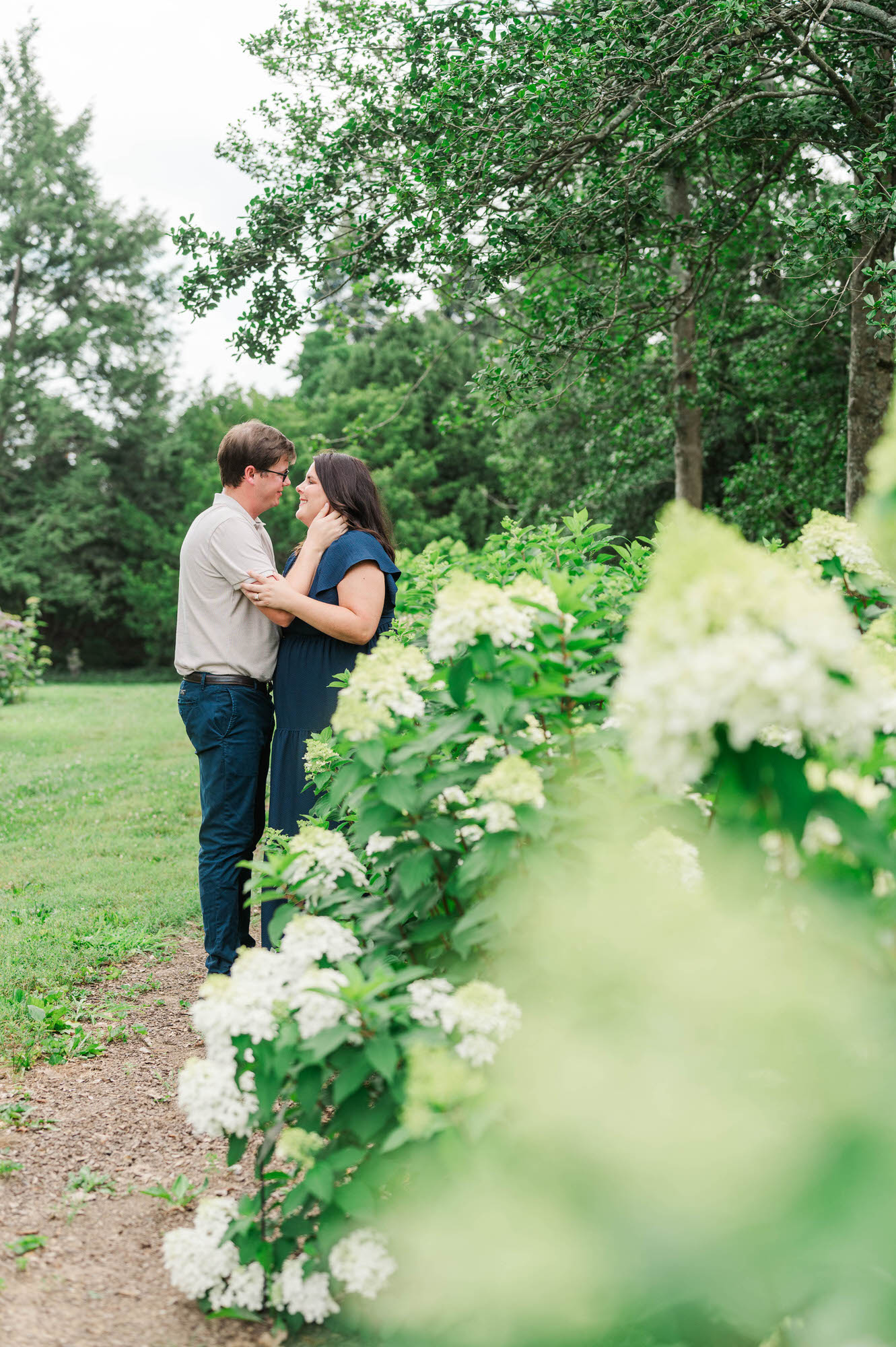 Couple stands amongst flowers at Yew Dell Botanical Gardens for their couples session in Louisville, KY