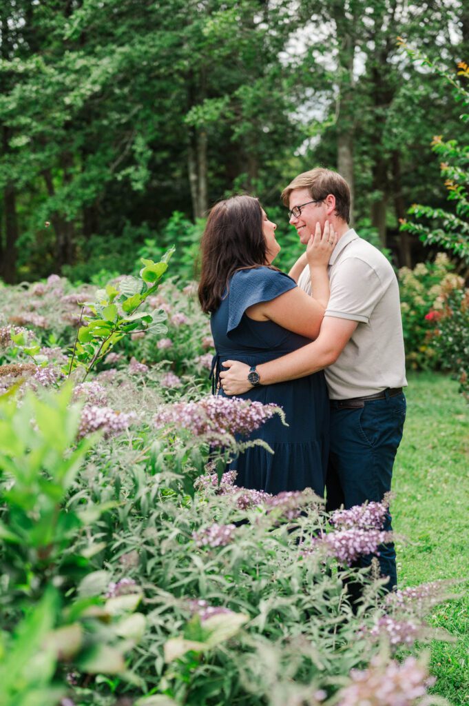 Couple stands amongst flowers at Yew Dell Botanical Gardens for their couples session in Louisville, KY