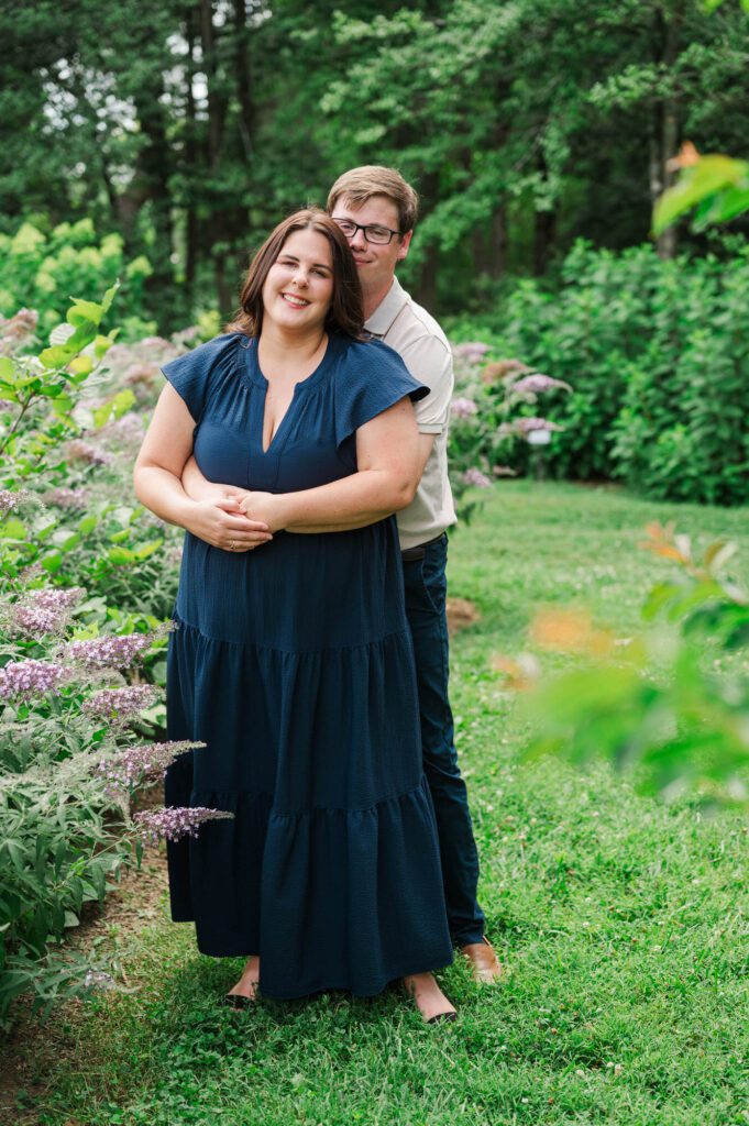 Couple stands amongst flowers at Yew Dell Botanical Gardens for their couples session in Louisville, KY