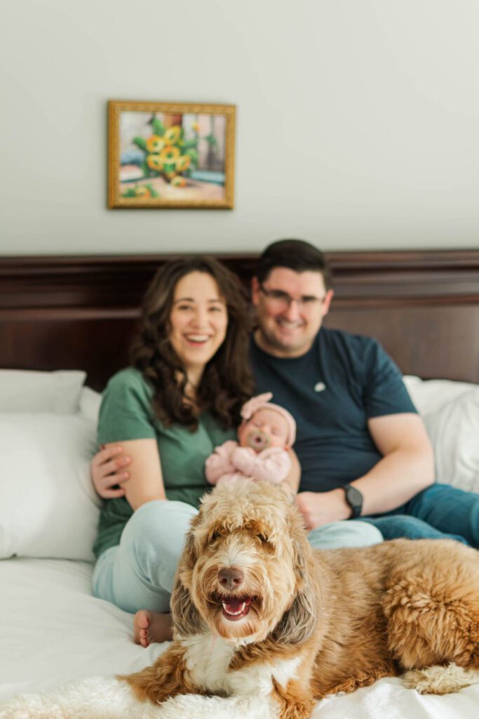 New parents hold their baby girl for their Louisville newborn photography session