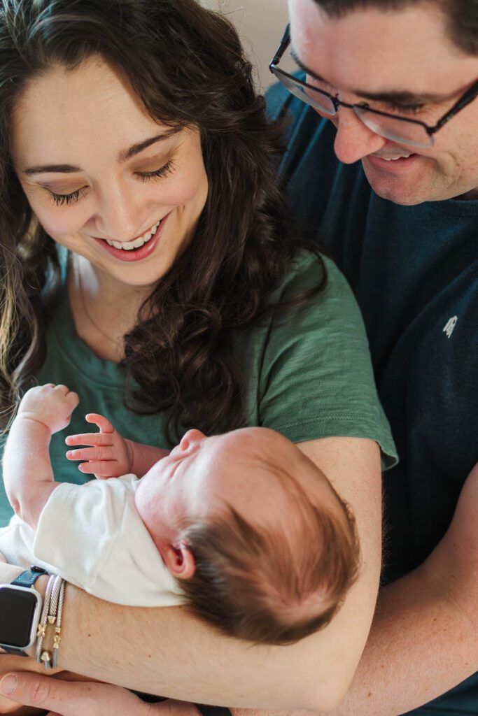 New parents hold their baby girl for their Louisville newborn photography session