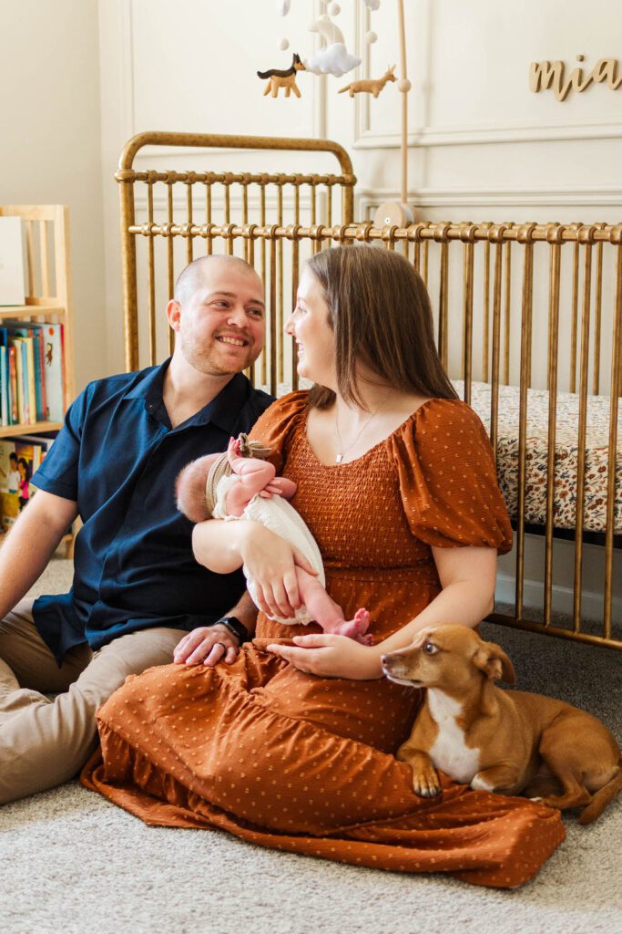 New parents hold newborn during their in-home photography session in Louisville, KY