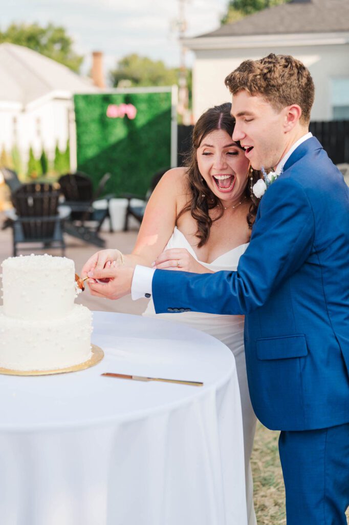 Bride and groom cut the cake on their wedding day at The Presley House Riverview in Warsaw, KY