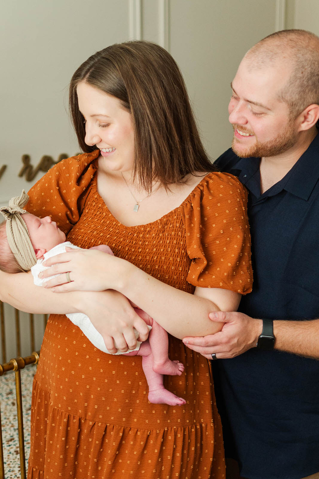 New parents hold newborn during their in-home photography session in Louisville, KY