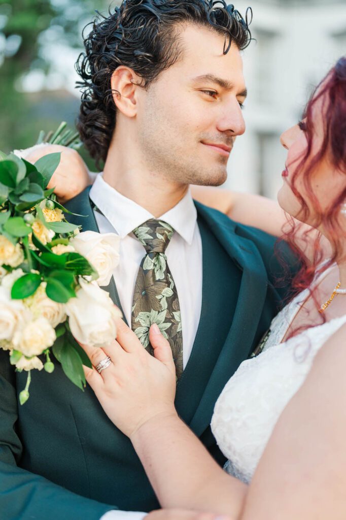 Bride and groom stand in front of Richwood on the River