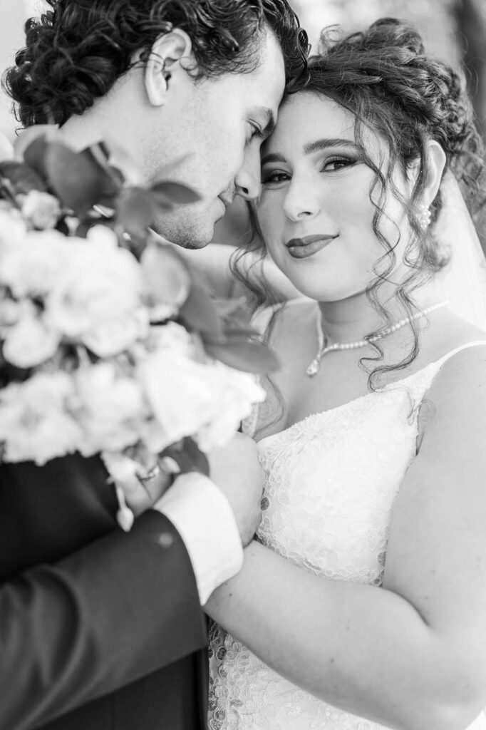 Bride and groom stand in front of Richwood on the River