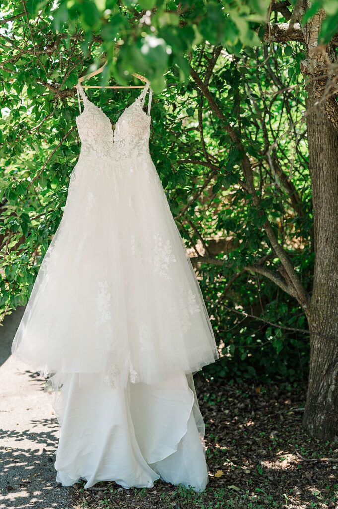 Dress hanging up before the start of a wedding day