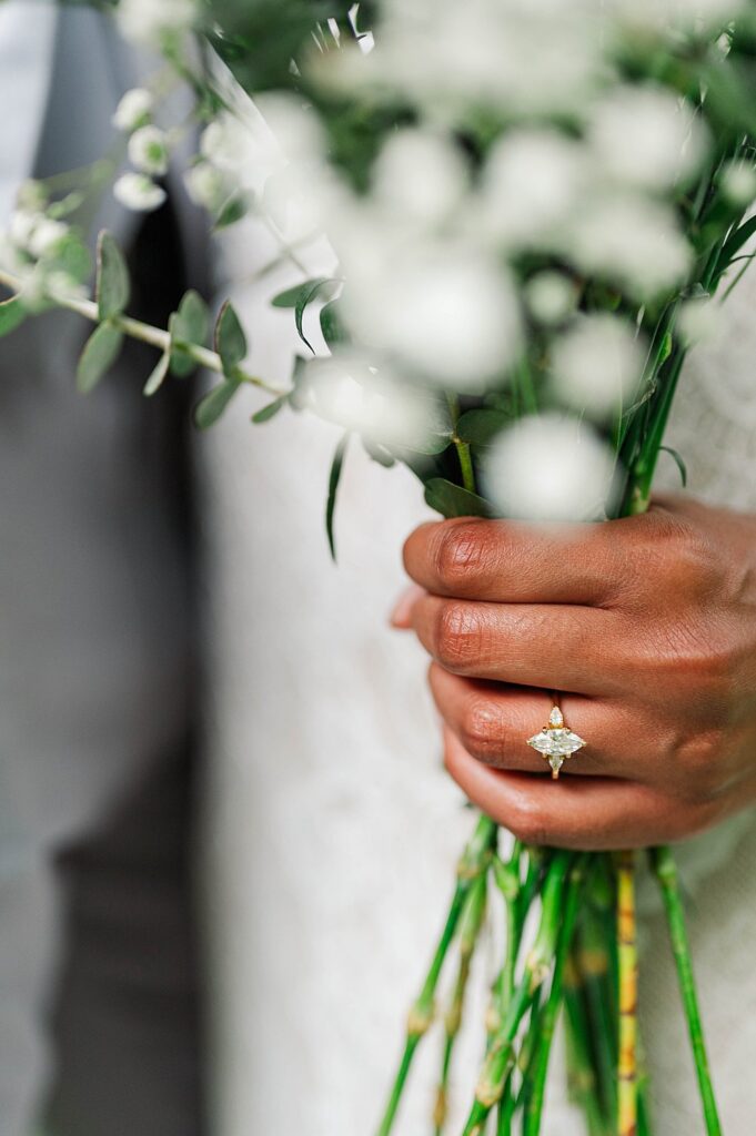 Close up of a ring and bridal bouquet