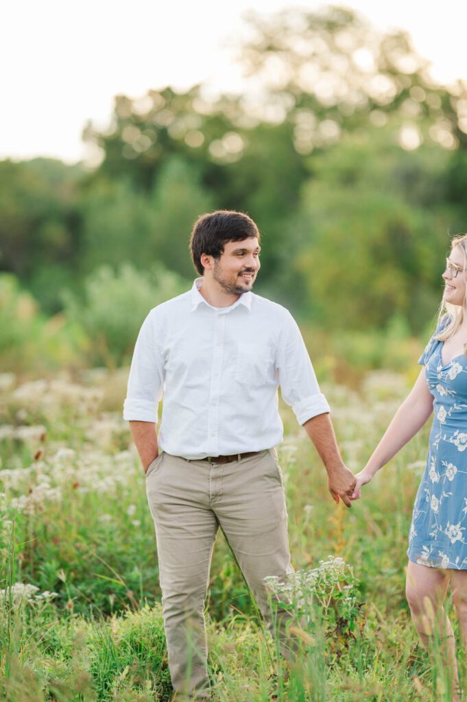 Couple walks hand in hand in Beckley Creek Park for their Louisville engagement session