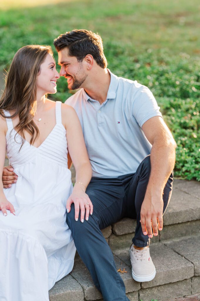 Couple sits together during their engagement session at Anchorage Trail in Louisville, KY