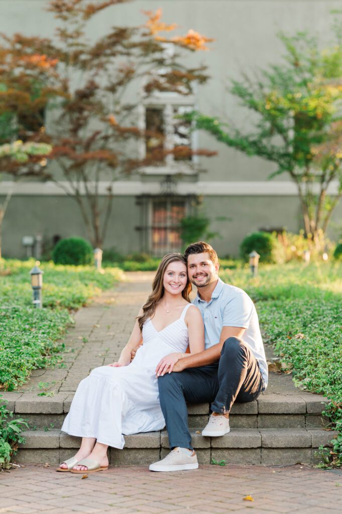 Couple sits together during their engagement session at Anchorage Trail in Louisville, KY