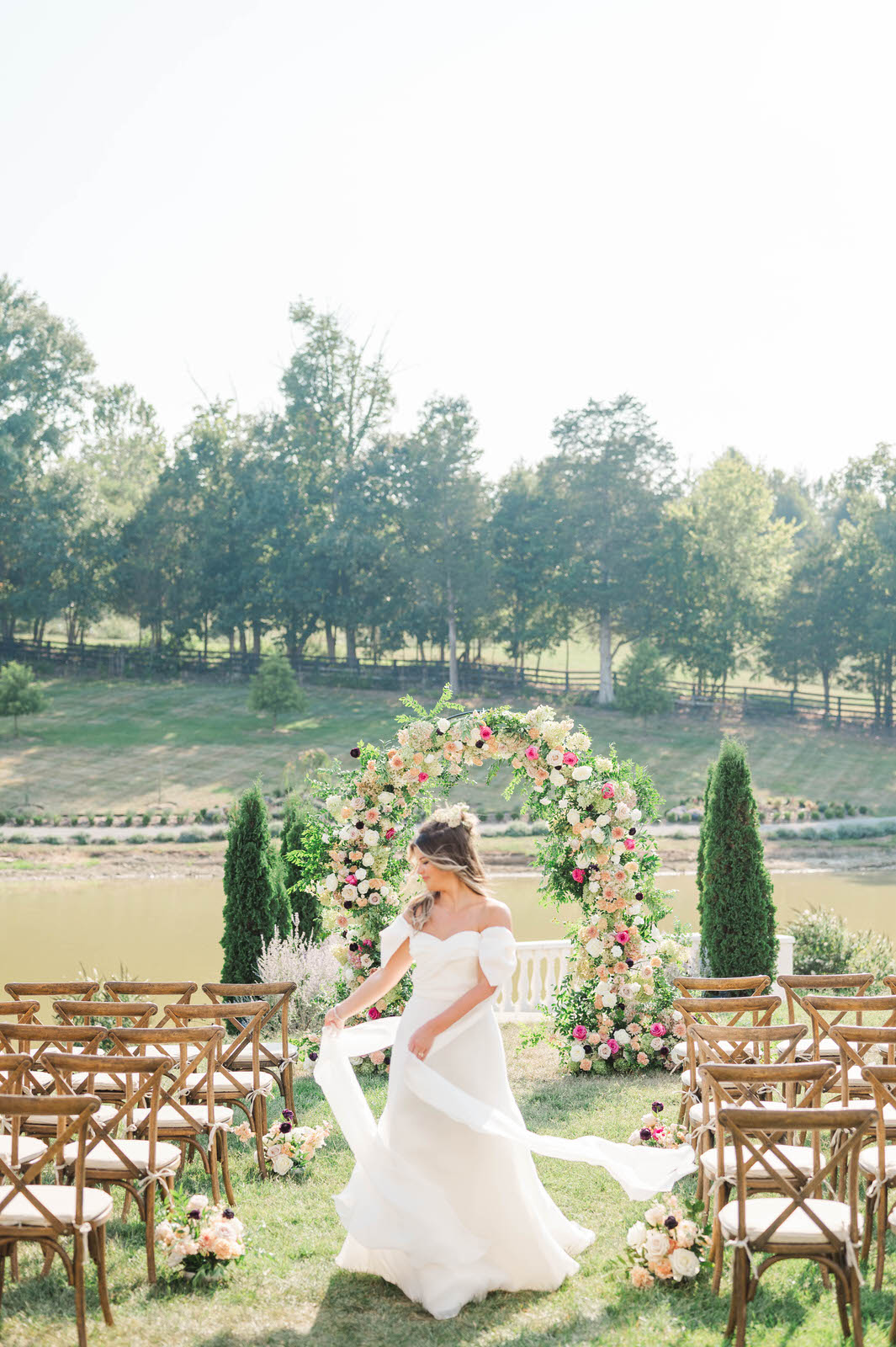 Bride stands in front of ceremony space at Hazelnut Farms