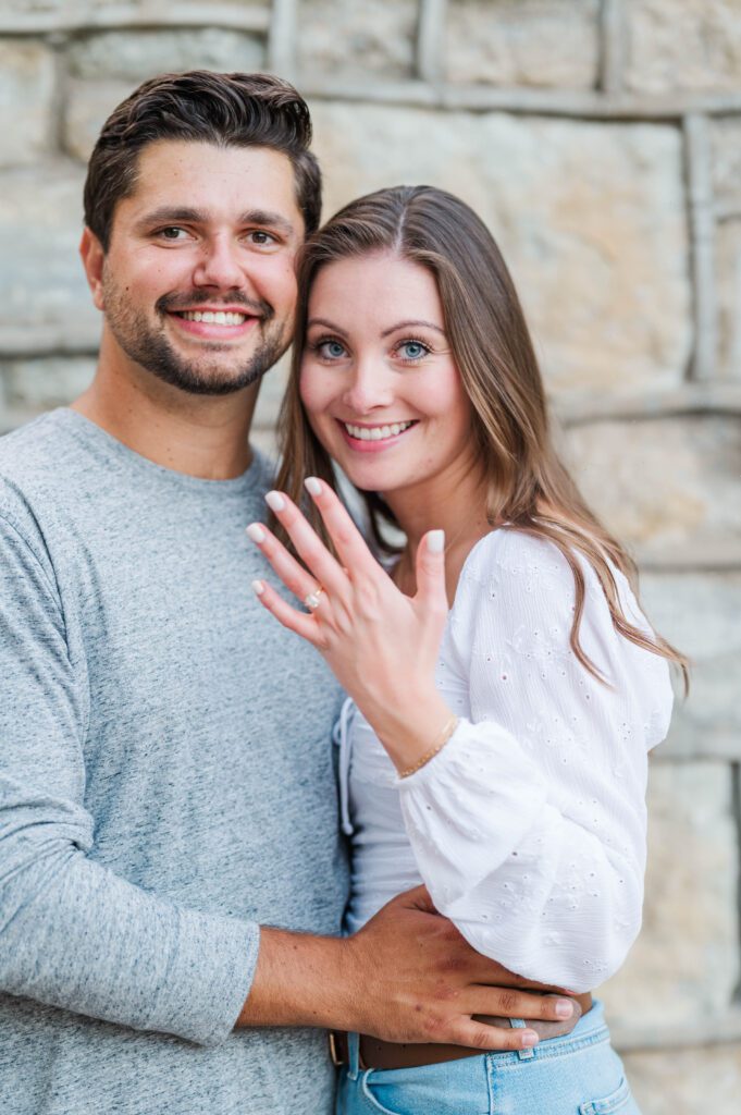 Couple shows off engagement ring during their engagement session at Anchorage Trail in Louisville, KY