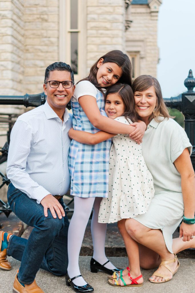 Family huddles together for their family session at the Crescent Hill Reservoir in Louisville, KY