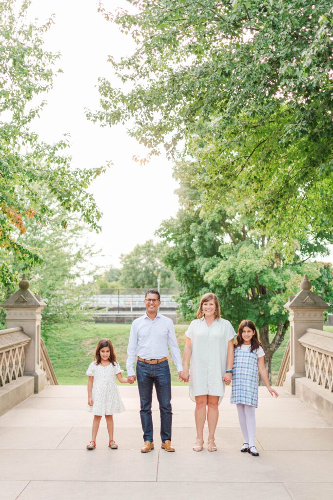 Family stands together on the stairs to the Crescent Hill Reservoir