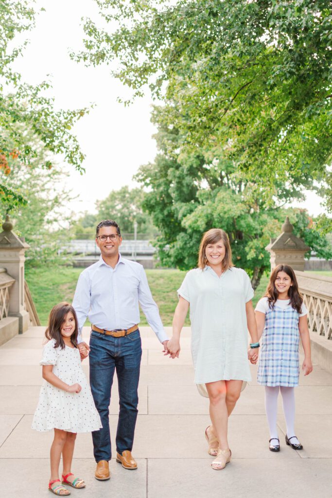 Family stands together on the stairs to the Crescent Hill Reservoir