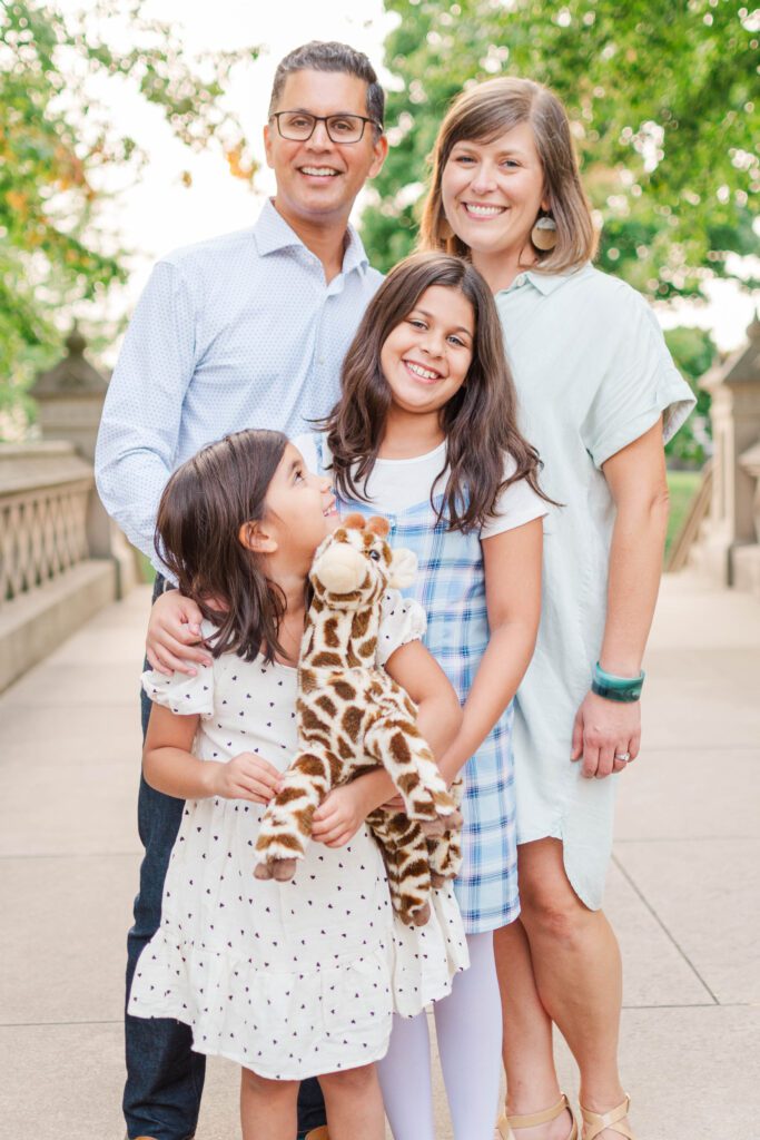 Family huddles together for their family session at the Crescent Hill Reservoir in Louisville, KY