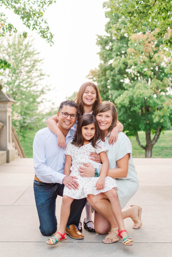 Family huddles together for their family session at the Crescent Hill Reservoir in Louisville, KY