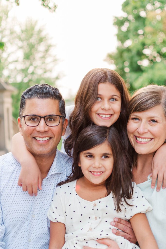 Family huddles together for their family session at the Crescent Hill Reservoir in Louisville, KY