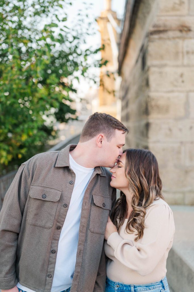 Couple stands together at Roebling Bridge for their Cincinnati engagement photos