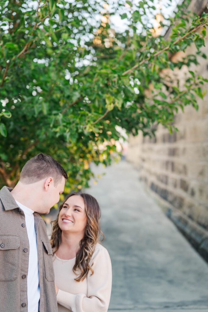 Couple stands together at Roebling Bridge for their Cincinnati engagement photos