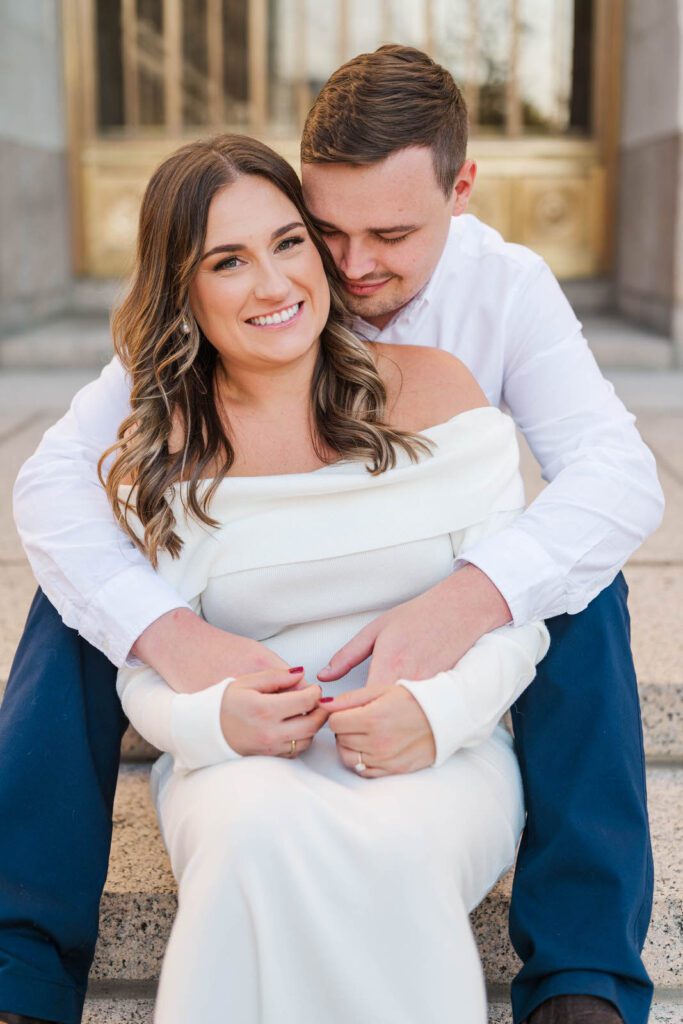 Couple sits together on the Hamilton County Courthouse steps for their Cincinnati engagement session