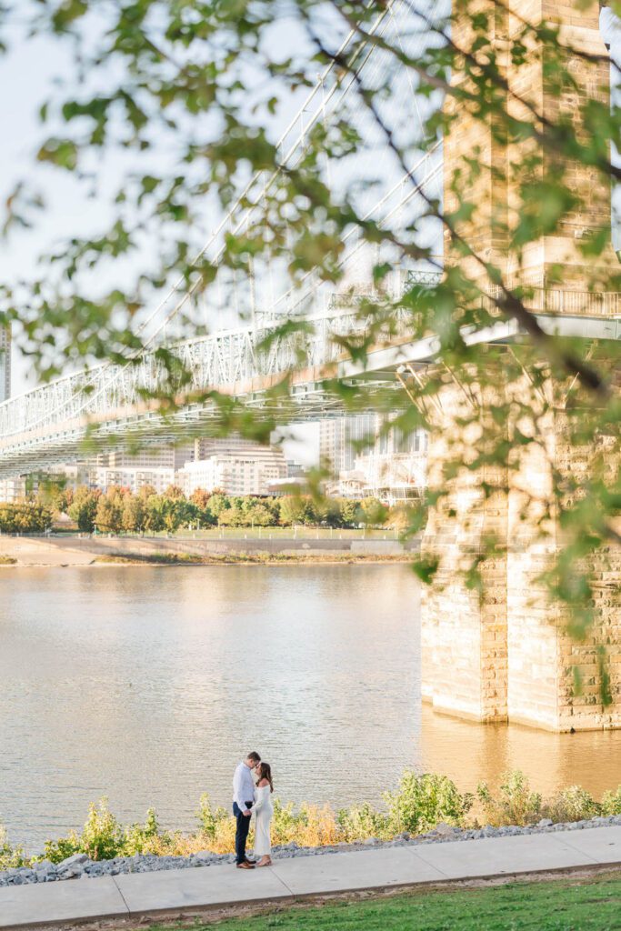 Couple stands together at Roebling Bridge for their Cincinnati engagement photos