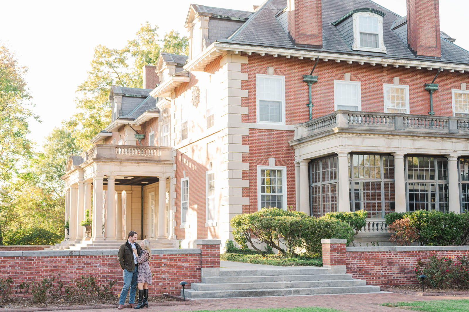 Couple stands together in front of Gardencourt in Louisville for their engagement session