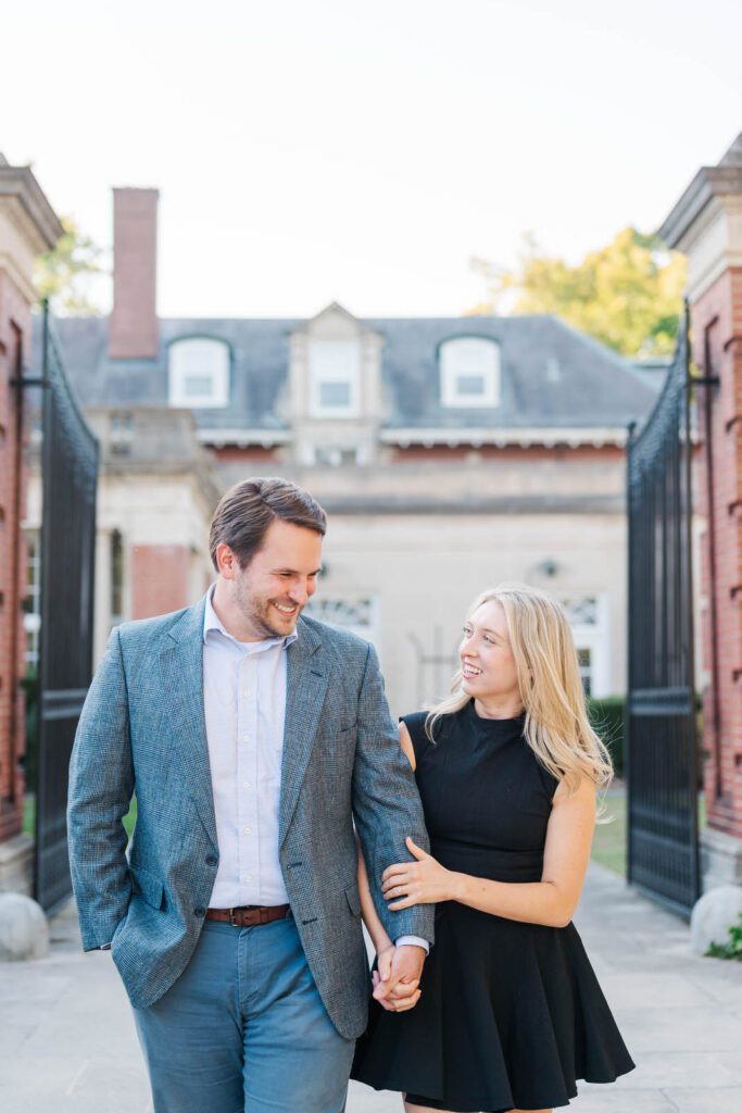 Couple walks in front of Gardencourt in Louisville for their engagement session