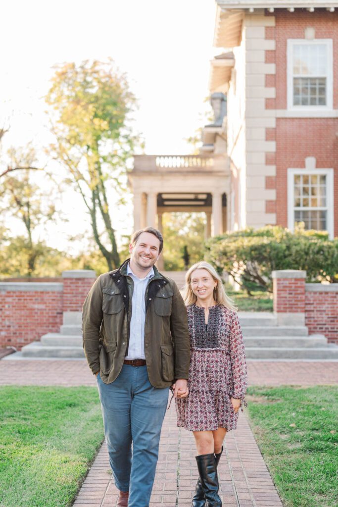 Couple walks in front of their wedding venue, Gardencourt in Louisville, KY