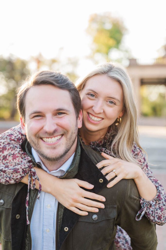 Couple laughs together in front of Gardencourt in Louisville for their engagement session