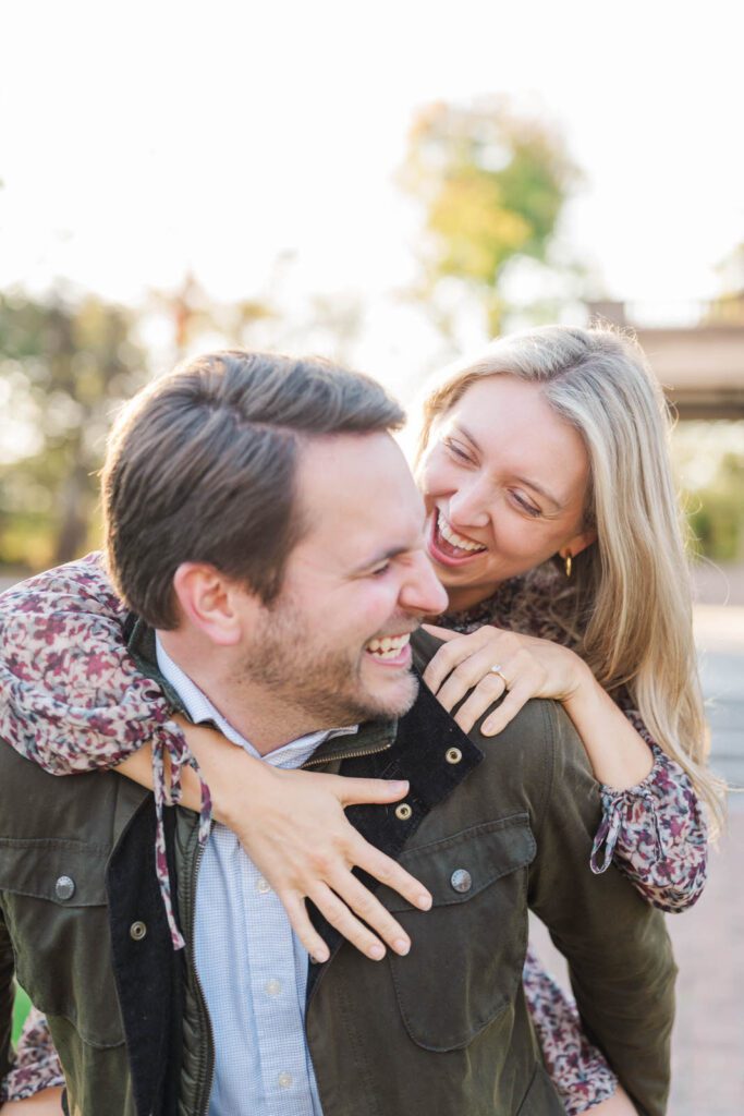 Couple laughs together in front of Gardencourt in Louisville for their engagement session