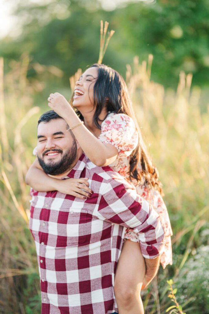 A piggy back ride during a couple's engagement session at Beckley Creek Park in Louisville, KY