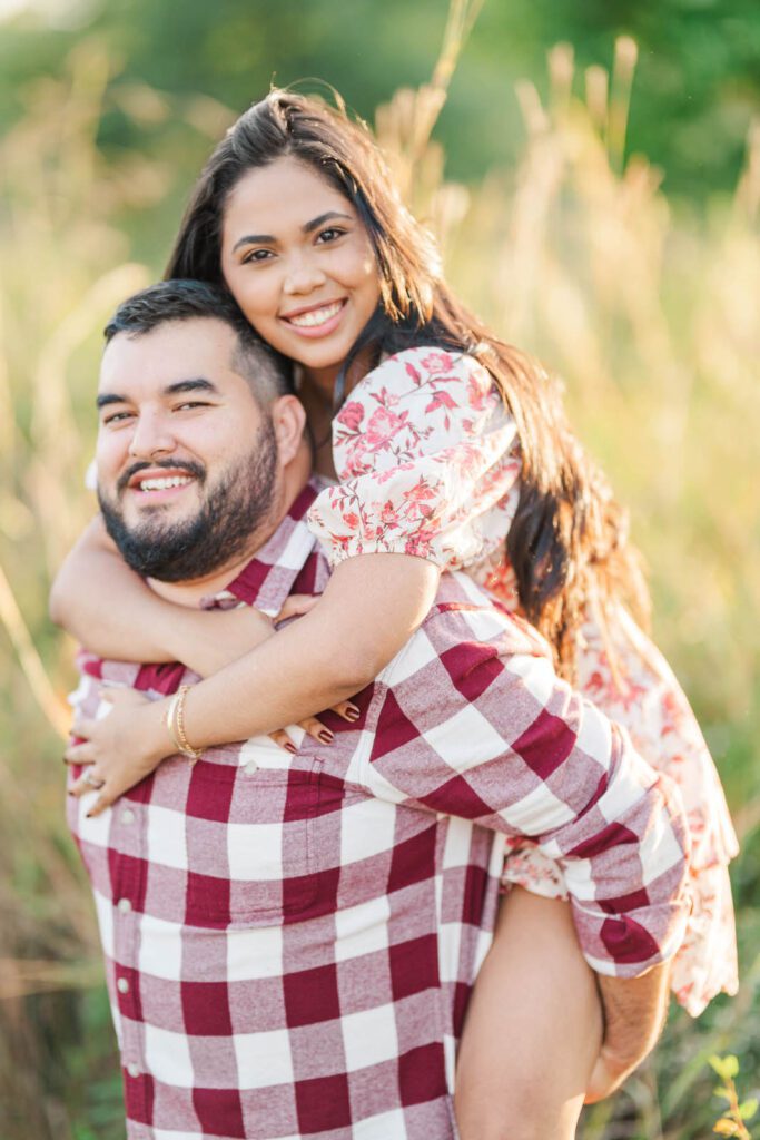 A piggy back ride during a couple's engagement session at Beckley Creek Park in Louisville, KY