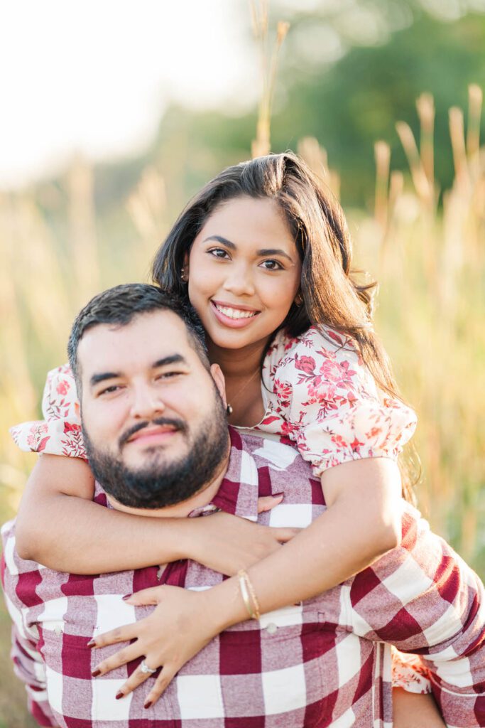 A piggy back ride during a couple's engagement session at Beckley Creek Park in Louisville, KY