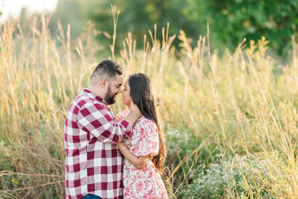 Couple stands close to one another during their engagement session at Beckley Creek Park in Louisville, KY