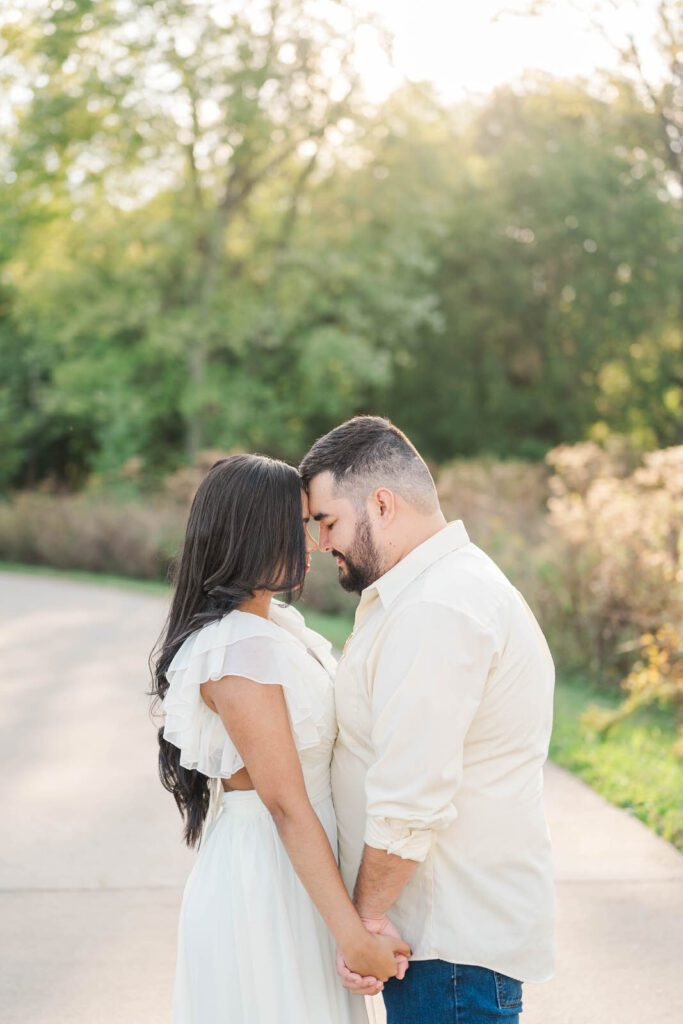 Couple stands close to one another during their engagement session at Beckley Creek Park in Louisville, KY