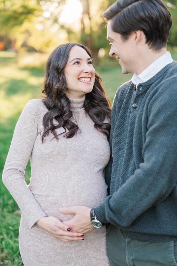 Couple laugh during their Cherokee Park maternity session