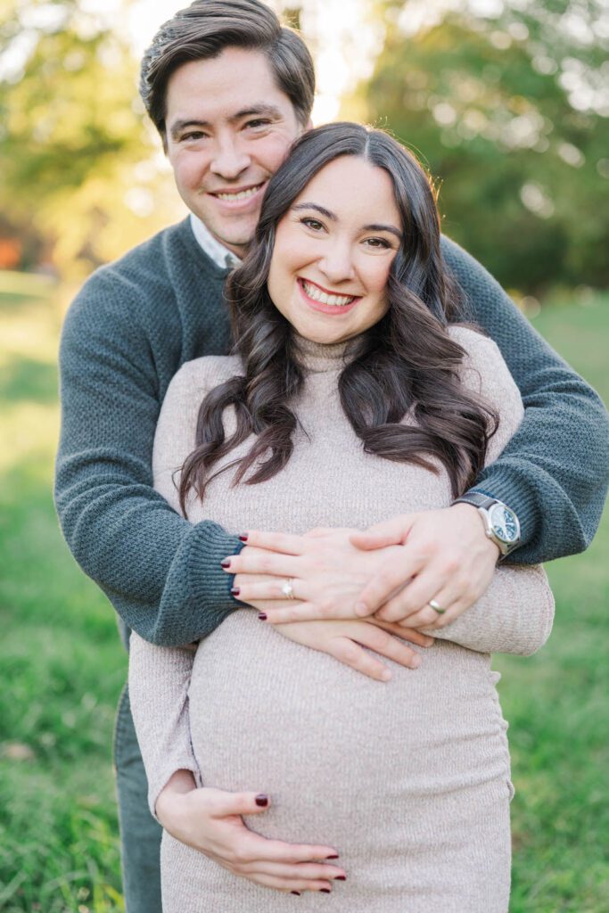 Couple smile at the camera during their Cherokee Park maternity session