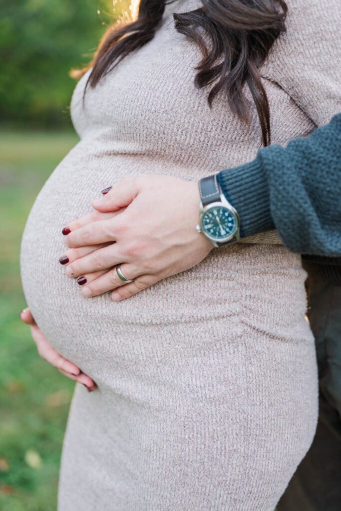 Close up of a baby bump during a maternity session at Cherokee Park