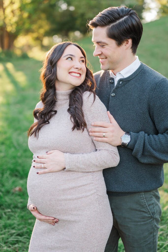 Parents-to-be embrace during their Cherokee Park maternity session