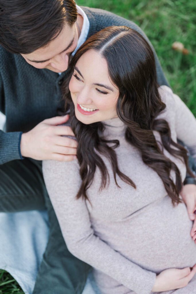 Couple embraces during their Cherokee Park maternity session