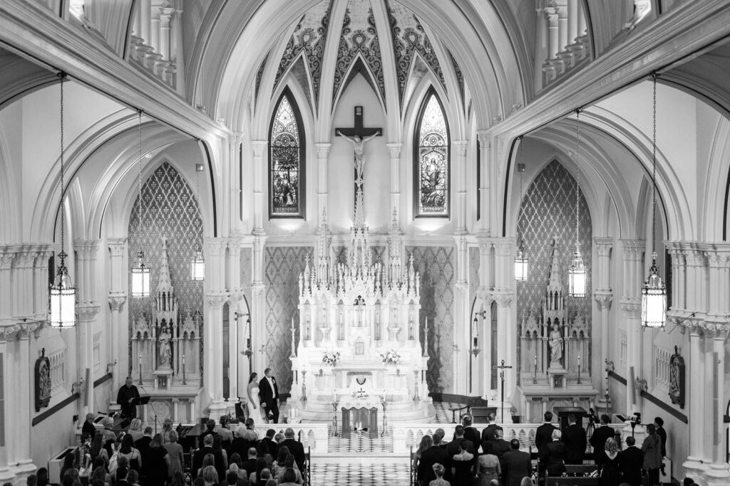 Bride and groom stand for their Catholic mass ceremony at Summit Country Day in Cincinnati