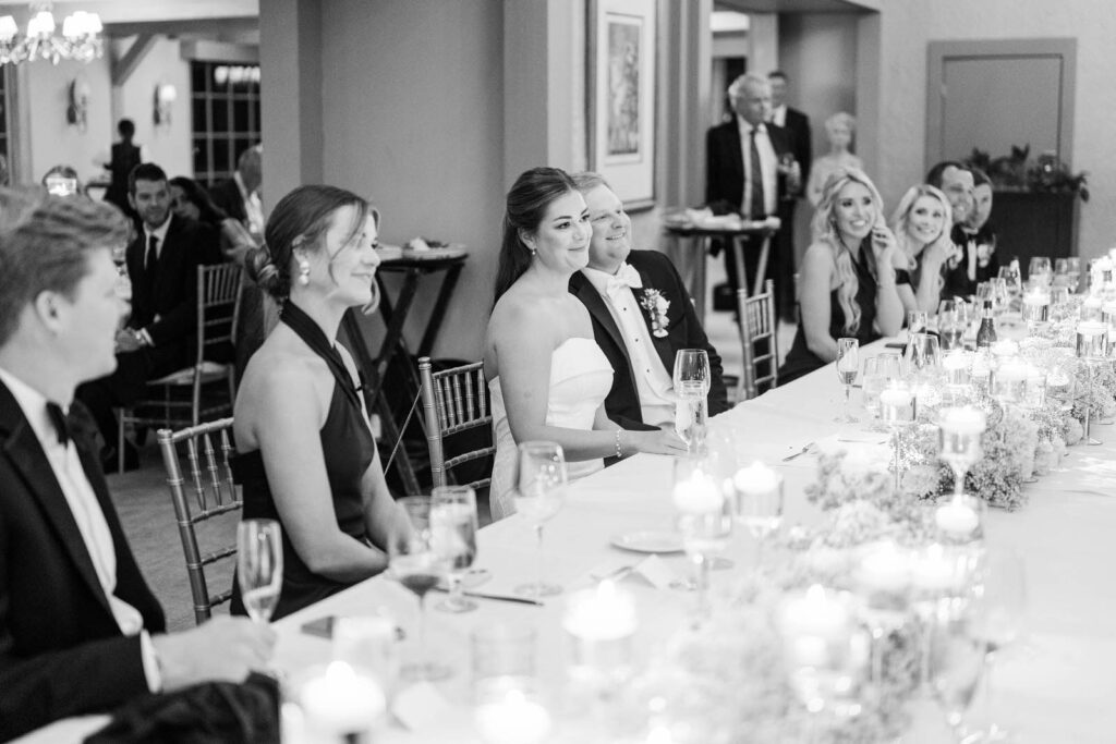 Bride and groom listen to toasts for their wedding at Kenwood Country Club