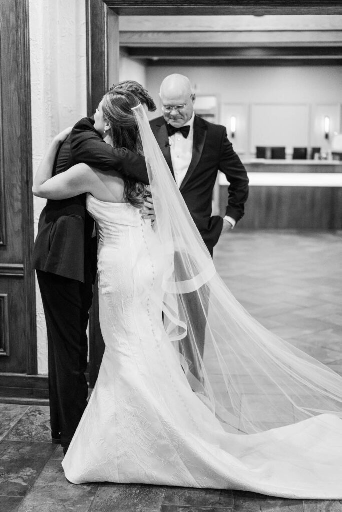 Bride hugs her brother for first look before her wedding at The Kenwood Country Club in Cincinnati