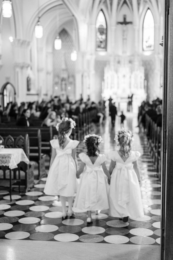 Flower girls walk down the aisle for a wedding at Summit Country Day