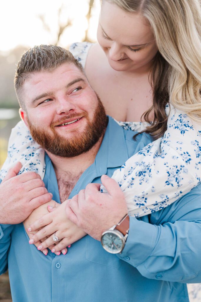 Engaged couple embraces at Beckley Creek Park during their engagement session.