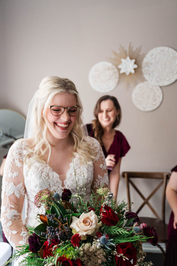 Bride laughs with bridesmaid while getting  ready for wedding day at The Gatewood in La Grange, KY