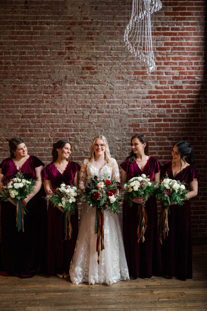 Bride stands with her bridesmaids