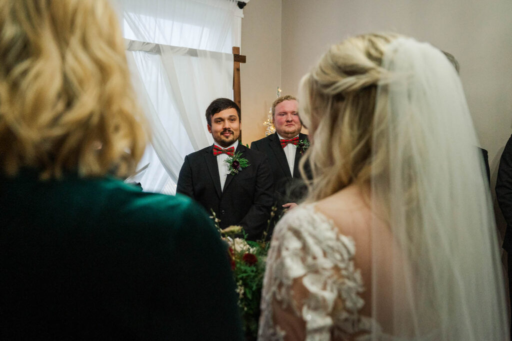 Groom looks at bride during the wedding ceremony